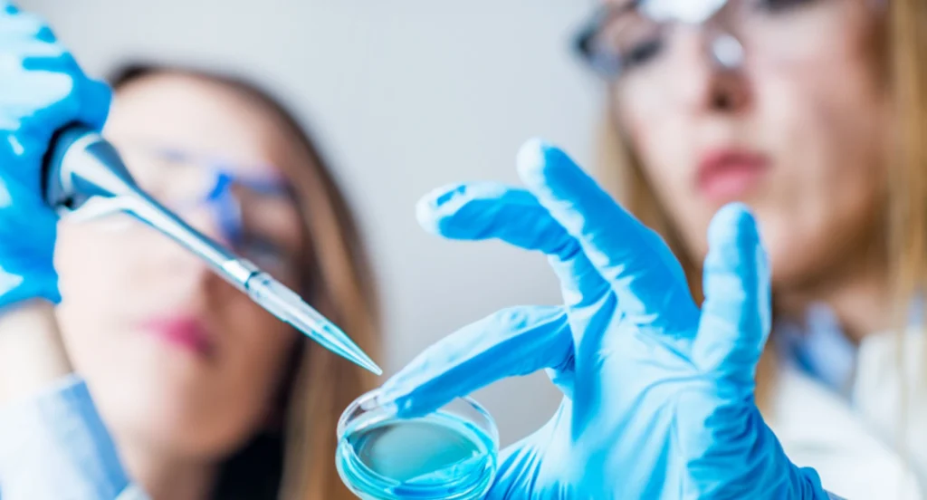 Two female scientists collaborating intently on a critical experiment, representing the mission-driven talent placed by CSS Scientific for pivotal life sciences roles.