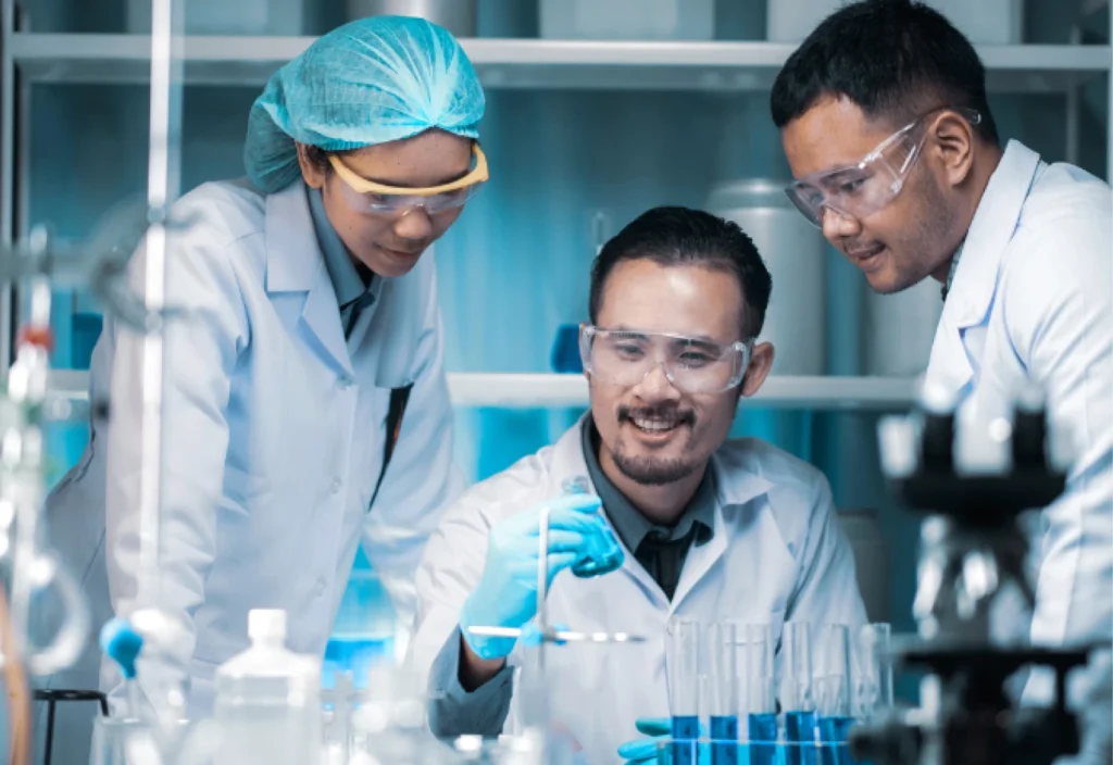 Team of three specialized scientists collaborating in a life sciences laboratory, showcasing the expert-level talent CSS Scientific delivers for R&D, QA/QC, and manufacturing roles.