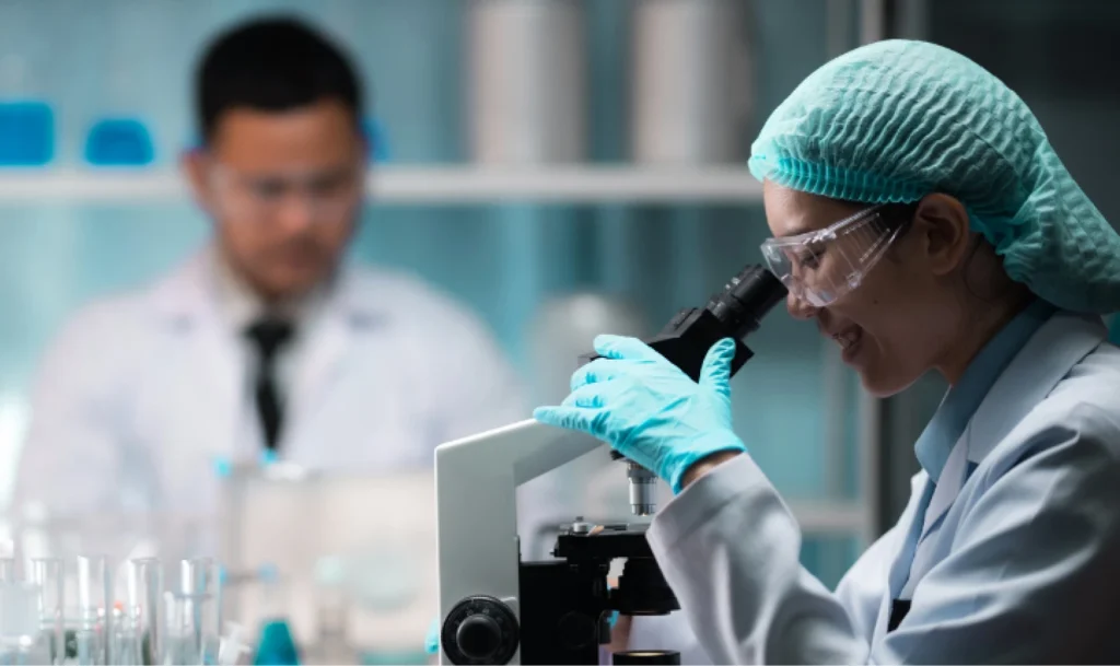 Dedicated life sciences recruitment team providing personalized care and attention to client needs, shown collaborating in a modern lab environment with test samples.